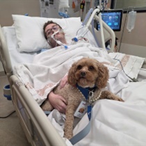 Austin Health ICU patient Robert with Lort Smith Pet Therapy dog Molly